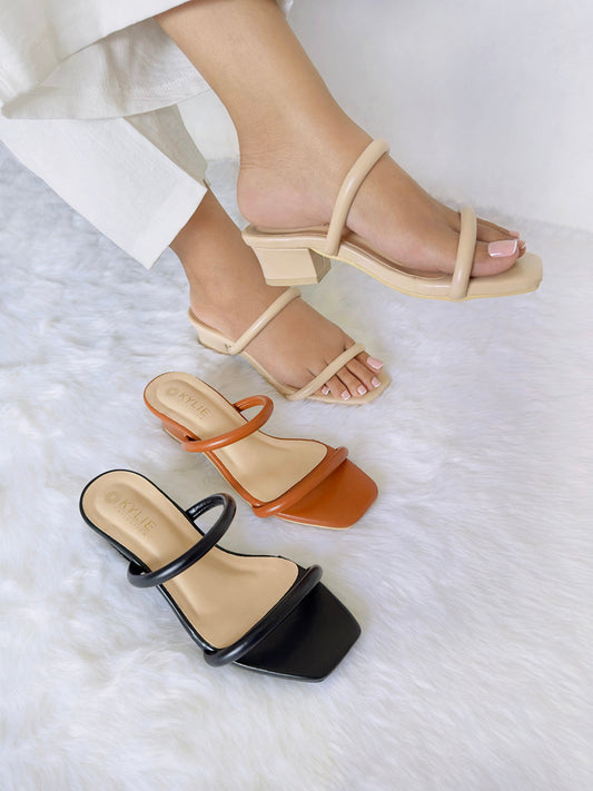 Top down view of Kylie Collection ladies heeled sandals featuring double straps in beige, brown, and black colors, with one pair worn by a model in Sri Lanka