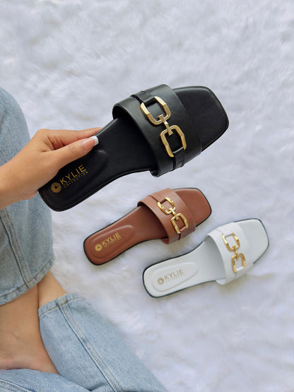 Three slide sandals in black, brown, and white colors