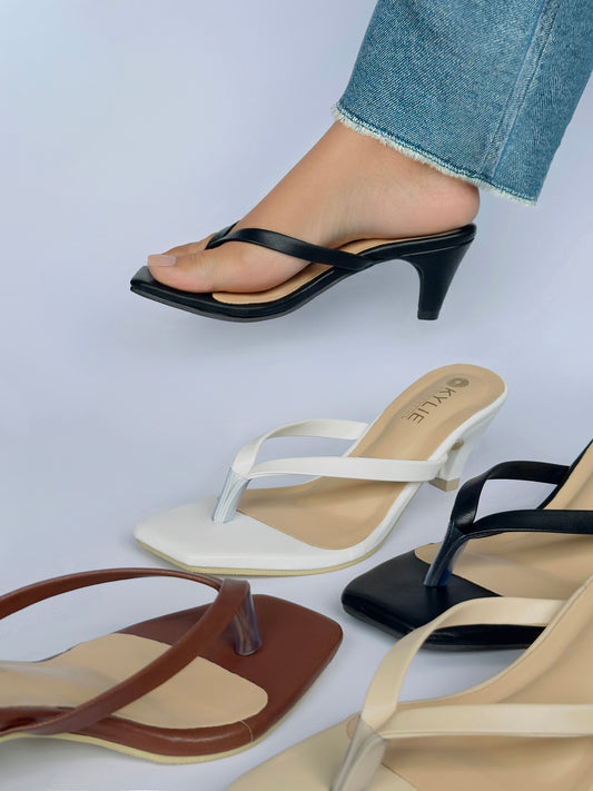 Close up of Kylie Collection ladies heeled sandals with classic thong straps, featuring black, white, brown, and nude colors shown on model and display in Sri Lanka