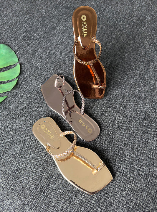 Kylie Collection ladies metallic copper, silver, and gold flat sandals with braided t-strap and toe ring details in Sri Lanka